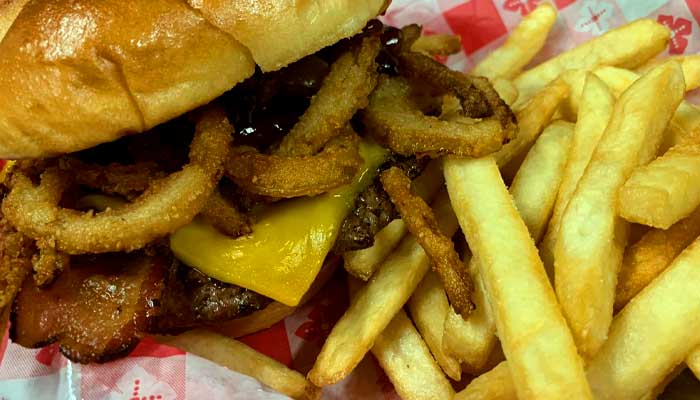 Gourmet cheeseburgers at Players Pizza & Pub restaurant and bar in Oshkosh are topped with onion rings, American cheese and thick cut bacon